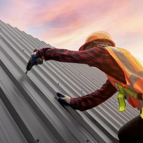 Metal roofing specialist installing a new Colorbond roof, with full service provided by Roofing Guys Perth including repairs and tile-to-metal conversions.