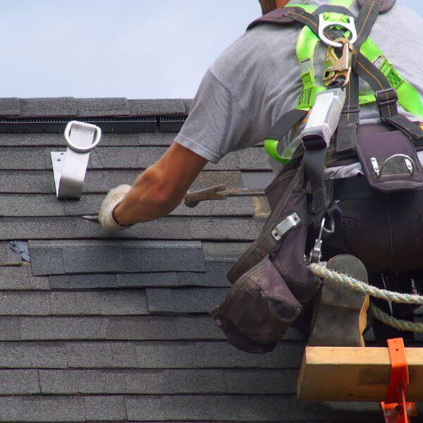 Roofing Guys Perth carrying out roof repairs by removing damaged shingles and restoring roof integrity.