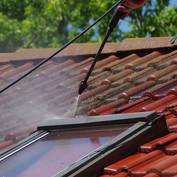 Roofing Guys Perth team providing professional roof cleaning using high-pressure washing to brighten and protect tiles.